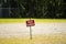 Baseball field with FIELD CLOSED sign in the middle