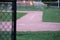 Baseball field from home plate to first base in early evening