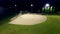 Baseball game on a field at a park in the evening