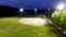 Baseball game on a field at a park in the evening