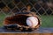 Baseball glove with ball in dugout