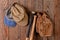 Baseball Glove and Hats hannging from a nail in a wood wall