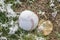 Baseball on grassy field covered in light dusting of snow