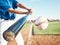 Baseball, hit and person on field for in closeup training, sports and fitness in outdoor competition. Hands, ball and