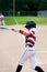 Baseball kid batting with a full swing.