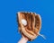 Baseball leather glove with white ball on hand