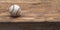 Baseball on a old rustic wooden desk with partial blur background