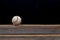 Baseball on a old rustic wooden desk with partial blur background