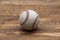 Baseball on a old rustic wooden desk with partial blur background