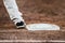 Baseball player with he\'s feet touching the base plate