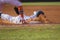 Baseball player sliding first base