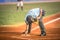 Baseball referee while cleaning the base