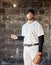 Baseball, sports and portrait of man with ball on wall background ready for game, match and practice. Softball mockup