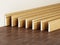 Baseboards with various profiles standing on hardwood surface. 3D illustration