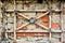 Basement bricked up window, antique red brick wall, vintage cast iron lattice