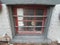 Basement window with skull decoration and bars