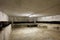 Basement with wine bottles and wooden table in old house interior