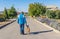 Basenji dog with master waking on a street