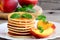 Basic pancakes with syrup and grilled fruit on a plate. Breakfast pancakes recipe for kids. Closeup