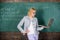 Basic school education. Teacher elegant lady with modern laptop surfing internet chalkboard background. Distance