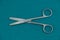 Basic surgical instrument stainless steel Straight operation scissors b/b isolated on surgical green drape fabric