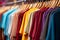 Basic t-shirts of different colors on a hanger in the store close-up