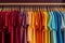 Basic t-shirts of different colors on a hanger in the store close-up