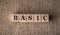 BASIC word written on wooden blocks on a brown background