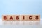 Basics word written on wood blocks on blue background. Back to basics or simplifying business concept