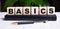 BASICS words are made up of building blocks that stand on a diary near the pen. Close-up