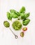 Basil pesto in glass jar with spoon,fresh leaves and tomatoes