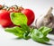 Basil tomatoes and garlic on white background