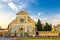 Basilica di Santa Maria Novella and green grass lawn with flowers on Piazza Santa Maria Novella square in Florence