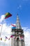 The Basilica of our Lady of the Rosary and flags of different countries against the blue sky. Lourdes, France, Hautes