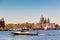 The Basilica of Saint Nicholas Sint-Nicolaasbasiliek, skyline and river with boats and ships during summer sunny day in Amsterdam