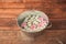 Basin with flowers on wooden background.