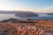 Baska - Panoramic sunrise view of deserted island Prvic seen from idyllic hiking trail near coastal town Baska