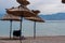 Baska - Straw umbrellas and loungers on idyllic pebble beach in resort town Baska, Krk Otok, Primorje-Gorski Kotar, Croatia