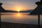 Baska - Straw umbrellas at sunset on idyllic pebble beach in tourist resort town Baska, Krk Otok, Primorje-Gorski Kotar