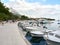 Baska Voda, Dalmatia, Croatia - July 19, 2021: Rainbow over the city. View of the promenade, marina and Biokovo Mountains