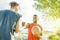 Baskeball players shakings hand before two on two game - Multiracial basket athletes showing respect clapping hand - Fair