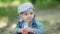 Basket with apples close. Joyful child in nature. Toddler in denim suit and a cap