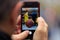 Basket ball picture appears on tablet, smartphone in man`s hands. Blurred background