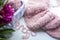 A basket with a bobbin fluffy pink yarn and a knitted piece