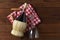 A basket bottle of Chianti wine on a red and white checked napkin with corkscrew. High angle shot