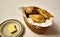 Basket of breads and butter on a plate served before main meal