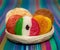 Basket with a bunch of typical mexican coconut candies honey cocada traditional mexican flag carpet background isolated colors