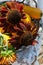 basket on a chair with ripe yellow pumpkin and brown unique sunflowers, harvest