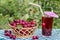 Basket of cherries and cherry beverage (compote, juice) on background of cherry tree