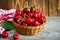 A basket with cherrys on wooden table